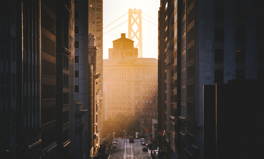 Sunlight peeking through an alley between San Francisco buildings.