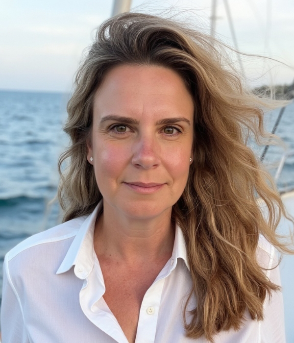 Photo of Anahata Neuman, M.A. Clinical Psychology, in front of a body of water.