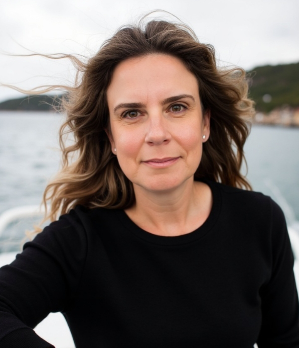 Photo of Anahata Neuman, M.A. Clinical Psychology, by a body of water.
